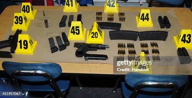 In this handout crime scene evidence photo provided by the Connecticut State Police, shows firearms and ammunition found on or in close proximity to...