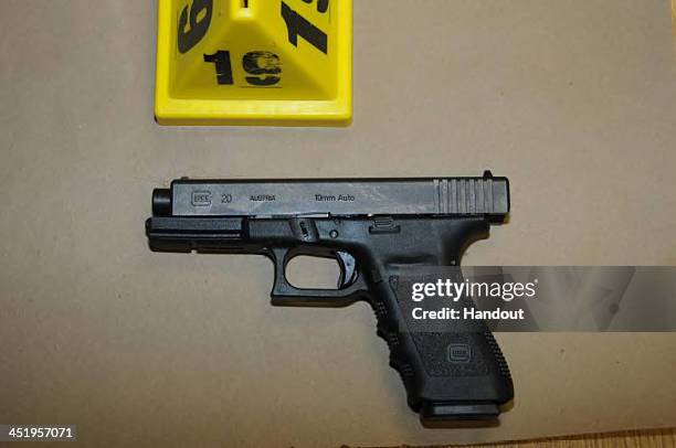 In this handout crime scene evidence photo provided by the Connecticut State Police, shows a Glock 20, 10mm found near the shooter in Room 10 at...