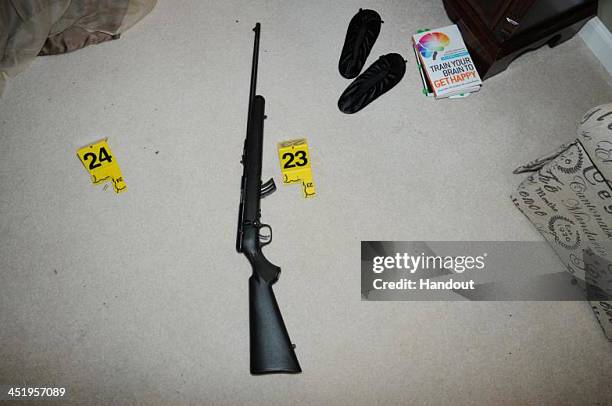 In this handout crime scene evidence photo provided by the Connecticut State Police, shows a rifle in the master bedroom in the suspect's house on...