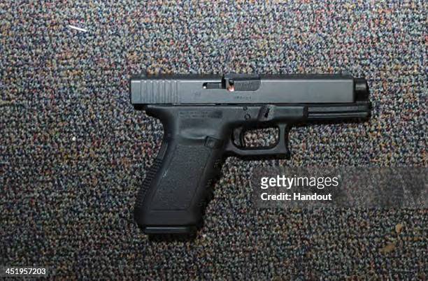 In this handout crime scene evidence photo provided by the Connecticut State Police, shows a Glock 20, 10mm found near the shooter in Room 10 at...