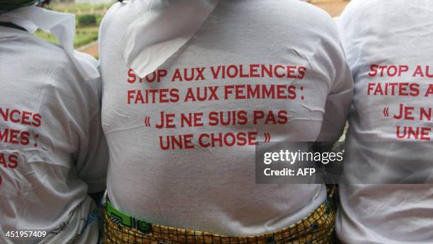 Women wear t-shirts reading "Stop violence against women: 'I am not a thing'" as they gather on the steps of the National Assembly in Bangui, the...