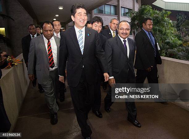 Japan's Prime Minister Shinzo Abe and Papua New Guinea Prime Minister Peter O'Neil walk after a meeting at the Papua New Guinea Parliament in Port...