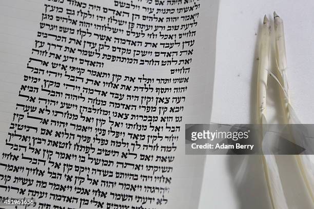 The tools of Rabbi and Torah Scribe Reuven Yaacobov are seen on a table on July 10, 2014 in the Jewish Museum in Berlin, Germany. In another room...