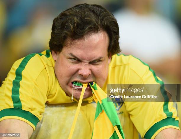 An emotional Brazil fan reacts after being defeated by Germany 7-1 after the 2014 FIFA World Cup Brazil Semi Final match between Brazil and Germanyat...
