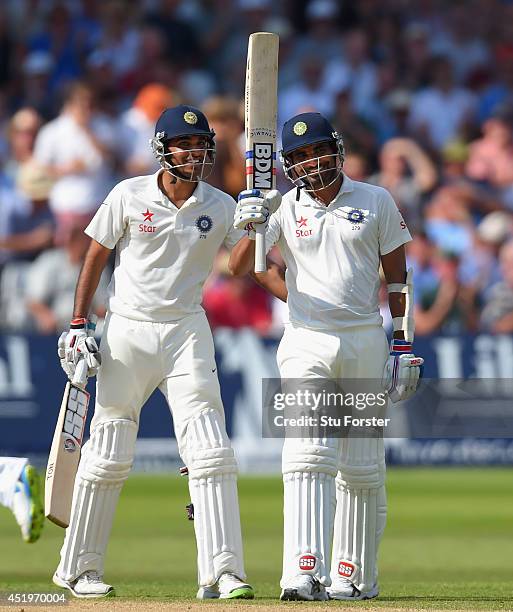 India batsman Mohammed Shami and partner Bhuvneshwar Kumar celebrate their 100 partnership for the last wicket and Shami's 50 which he had reached...
