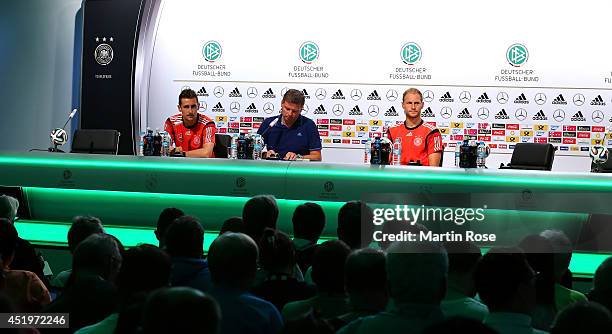 Miroslav Klose adn Benedikt Hoewedes of Germany talk to the media during the German national team press conference at Campo Bahia on July 10, 2014 in...