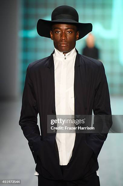Model walks the runway at the Umasan show during the Mercedes-Benz Fashion Week Spring/Summer 2015 at Erika Hess Eisstadion on July 10, 2014 in...