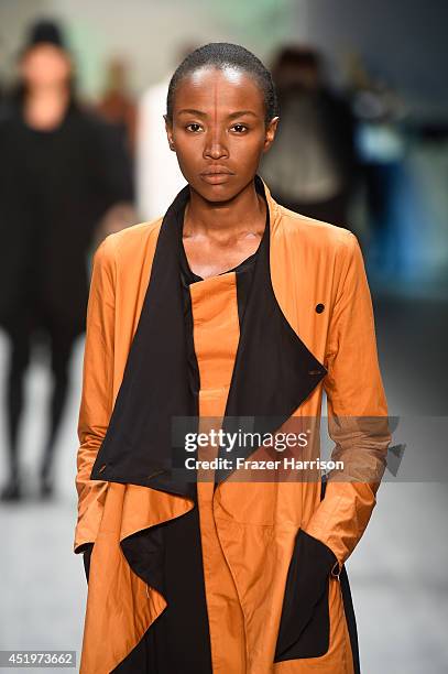 Model walks the runway at the Umasan show during the Mercedes-Benz Fashion Week Spring/Summer 2015 at Erika Hess Eisstadion on July 10, 2014 in...