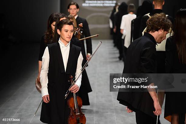 Musicians and models walk the runway at the Umasan show during the Mercedes-Benz Fashion Week Spring/Summer 2015 at Erika Hess Eisstadion on July 10,...