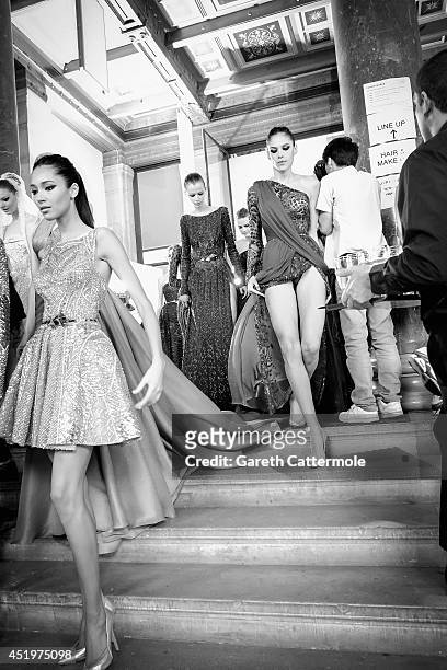Models rush to change looks backstage during the Zuhair Murad show as part of Paris Fashion Week - Haute Couture Fall/Winter 2014-2015 at Palais Des...