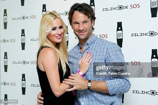 Carolina Cerezuela and Carlos Moya attend Omega Pharma Silincode SOS Charity Bracelet presentation on July 10, 2014 in Madrid, Spain.