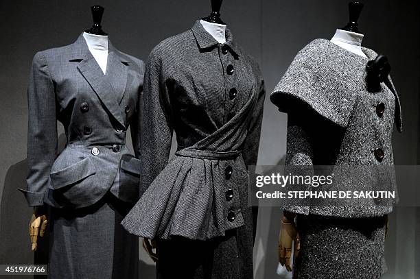 Three couture creations by fashion designers Balenciaga, Christian Dior and Pierre Cardin are displayed on July 10, 2014 at the Palais Galliera in...