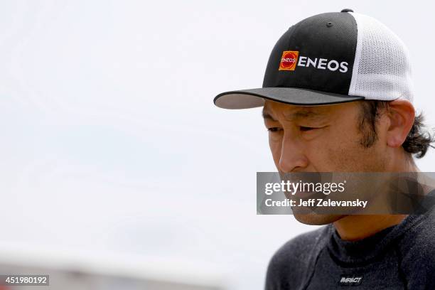 Akinori Ogata, driver of the ENEOS Toyota stands in the garage area during practice for the Granite State 100 in the K&N Pro Series East at New...