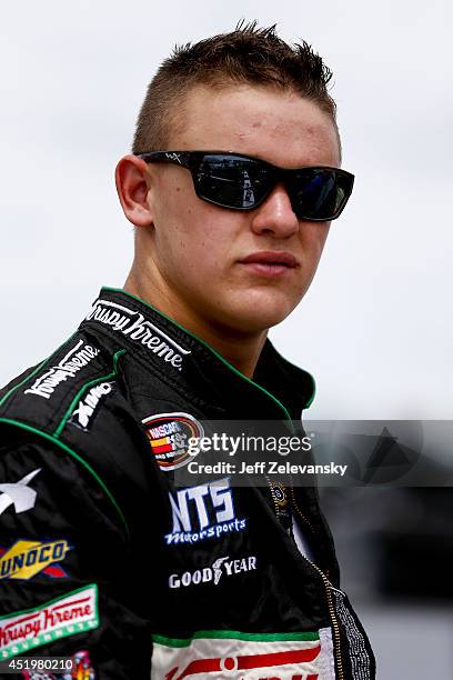 Gray Gaulding, driver of the Krispy Kreme Chevrolet stands in the garage area during practice for the Granite State 100 in the K&N Pro Series East at...