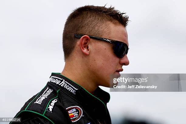 Gray Gaulding, driver of the Krispy Kreme Chevrolet stands in the garage area during practice for the Granite State 100 in the K&N Pro Series East at...