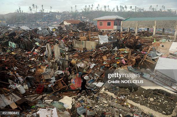 Man searches for salvageable materials among destroyed houses in Tacloban, Leyte province, on November 26, 2013. The swift US humanitarian response...
