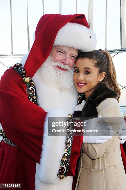 Ariana Grande and Santa Claus visit The Empire State Building in honor of the 87th Annual Macy's Thanksgiving Parade on November 25, 2013 in New York...