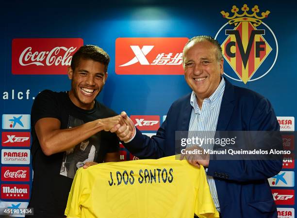 Jonathan Dos Santos poses with the Villarreal CF president Fernando Roig during his presentation as a new player for Villarreal CF at the El Madrigal...