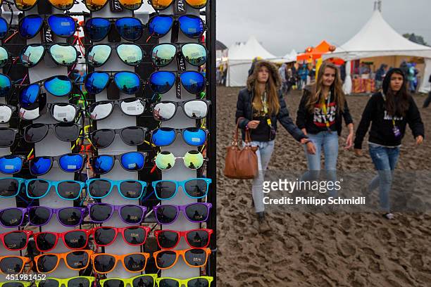 Festival-goers pass a sunglasses shop at Openair Frauenfeld on July 10, 2014 in Frauenfeld, Switzerland.