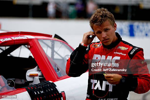 Cale Conley, driver of the Tait Towers/MPC Chevrolet stands in the garage area during practice for the Granite State 100 in the K&N Pro Series East...