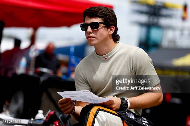 Jesse Little, driver of the NASCAR Technical Institute Chevrolet stands in the garage area during practice for the Granite State 100 in the K&N Pro...