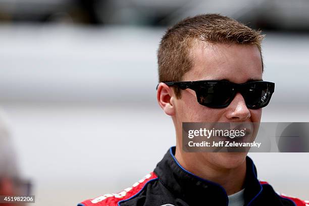 Ben Rhodes, driver of the Alpha Mechanical Chevrolet, stands in the garage area during practice for the Granite State 100 in the K&N Pro Series East...