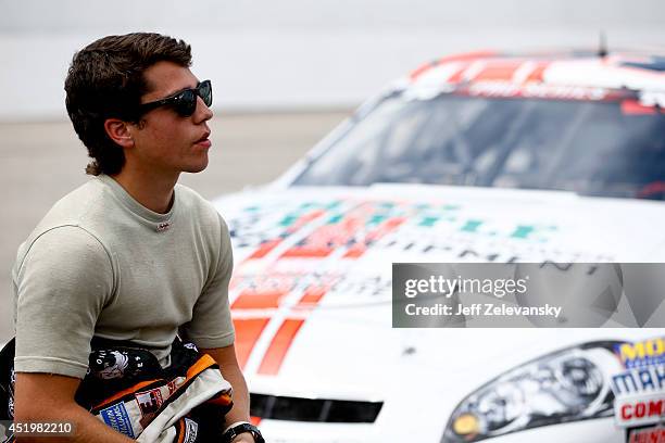 Jesse Little, driver of the NASCAR Technical Institute Chevrolet stands in the garage area during practice for the Granite State 100 in the K&N Pro...