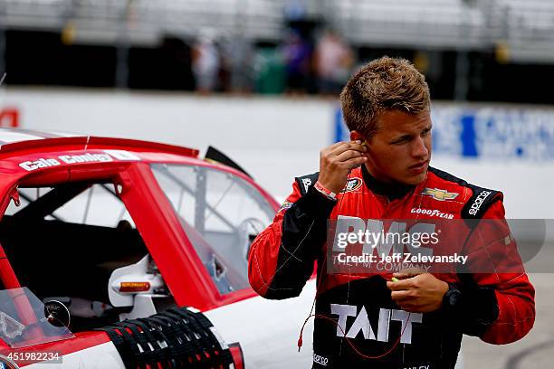 Cale Conley, driver of the Tait Towers/MPC Chevrolet stands in the garage area during practice for the Granite State 100 in the K&N Pro Series East...