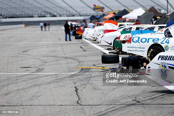 Crew work on cars during practice for the Granite State 100 in the K&N Pro Series East at New Hampshire Motor Speedway on July 10, 2014 in Loudon,...