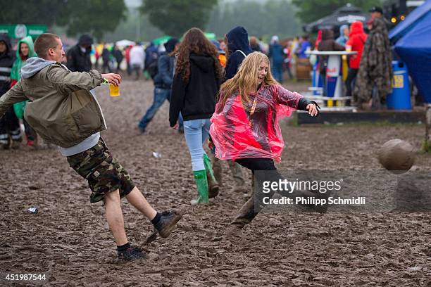 Festival-goers play football in the mud at Openair Frauenfeld on July 10, 2014 in Frauenfeld, Switzerland.