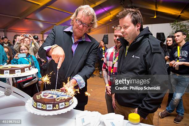 Wolfgang Sahli , president of the board of directors of Openair Frauenfeld cuts the 20 year anniversary celebration cake in the VIP area at Openair...