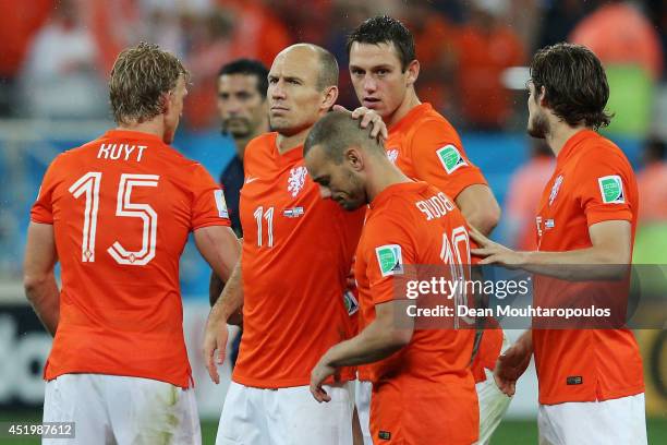 Wesley Sneijder and Arjen Robben of the Netherlands react with teammates after being defeated in a penalty shootout by Argentina during the 2014 FIFA...