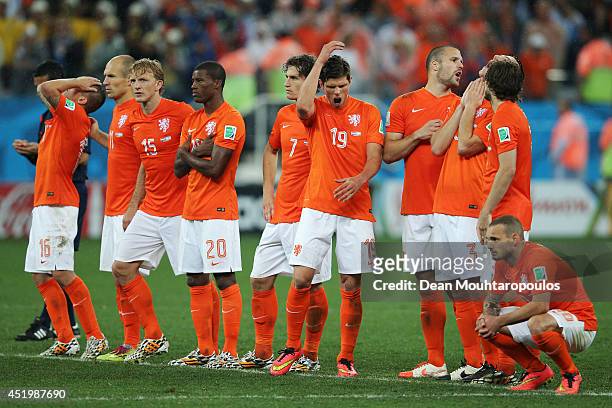 The Dutch team react during the penalty shootout with Argentina during the 2014 FIFA World Cup Brazil Semi Final match between the Netherlands and...