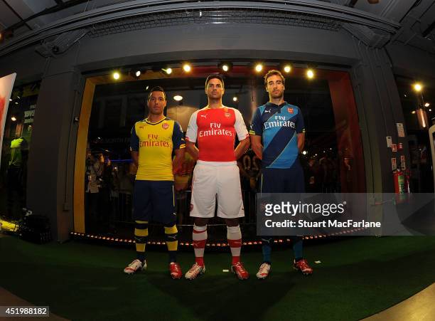Santi Cazorla, Mikel Arteta and Mathieu Flamini during the launch of Arsenal's new kits at the Puma store in Carnaby Street on July 10, 2014 in...