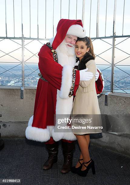 Ariana Grande and Santa Claus visit The Empire State Building in honor of the 87th Annual Macy's Thanksgiving Parade on November 25, 2013 in New York...