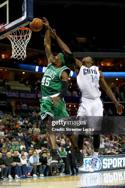 Michael Kidd-Gilchrist of the Charlotte Bobcats blocks Gerald Wallace of the Boston Celtics from behind during their game at Time Warner Cable Arena...