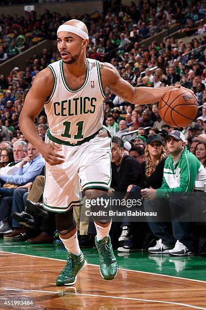 Jerryd Bayless of the Boston Celtics handles the ball against the Miami Heat on March 19, 2014 at the TD Garden in Boston, Massachusetts. NOTE TO...