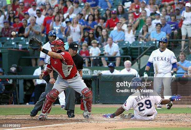 Adrian Beltre of the Texas Rangers slides in safe in the first inning against Hank Conger of the Los Angeles Angels of Anaheim on a two run double...
