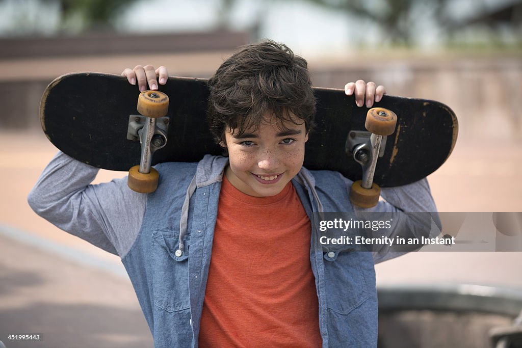 Boy hanging out with his skateboard