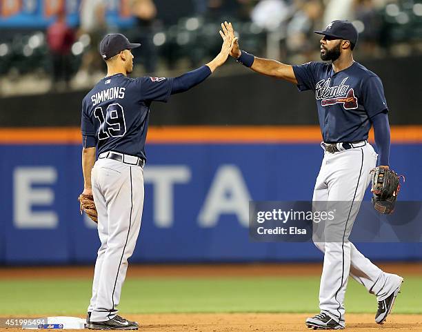 Andrelton Simmons and Jason Heyward of the Atlanta Braves celebrate the win over the New York Mets on July 10, 2014 at Citi Field in the Flushing...