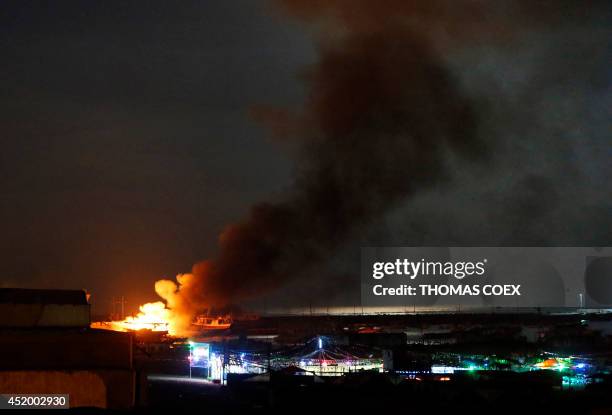 Canadian peace activist boat "Gaza's Ark" burns in Gaza harbour following an Israeli air strike on July 11, 2014 in Gaza City. The Gaza's Ark, one of...