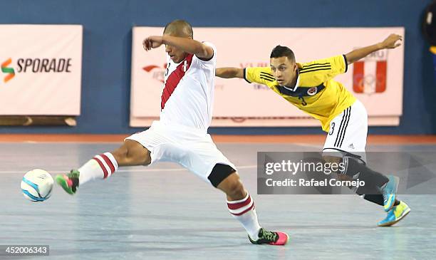 Renzo Ramirez of Peru fights for the ball with Luis Berreneche of Colombia during a match between Colombia and Peru as part of the XVII Bolivarian...