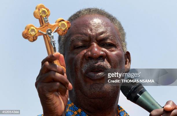 Zambia's controversial opposition leader and presidential candidate Michael Sata displays a cross to his supporters during his campaign for the...