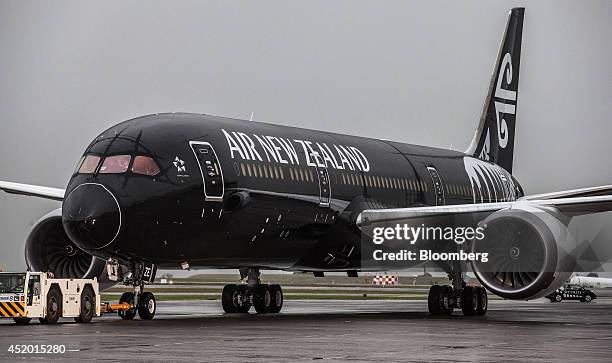 Boeing Co. 787-9 Dreamliner aircraft, operated by Air New Zealand Ltd., is towed across the tarmac by a tractor after touching down at Auckland...