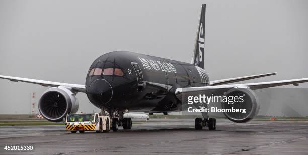 Boeing Co. 787-9 Dreamliner aircraft, operated by Air New Zealand Ltd., is towed across the tarmac by a tractor after touching down at Auckland...