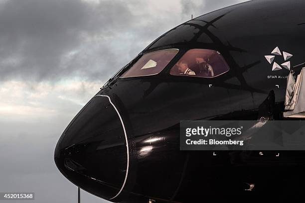Pilot sits inside the cockpit of a Boeing Co. 787-9 Dreamliner aircraft, operated by Air New Zealand Ltd., after touching down at Auckland...