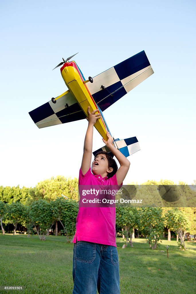 Little boy playing with toy airplane
