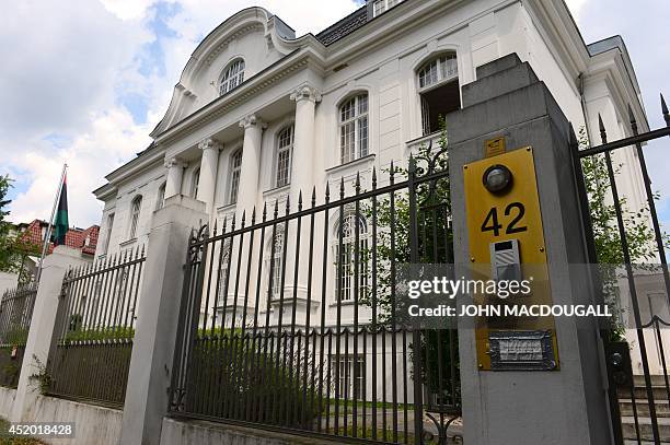 Libya's national flag is displayed outside the building hosting the Libyan Embassy to Germany in Berlin, on July 11 where a 25 year old Tunisian man...