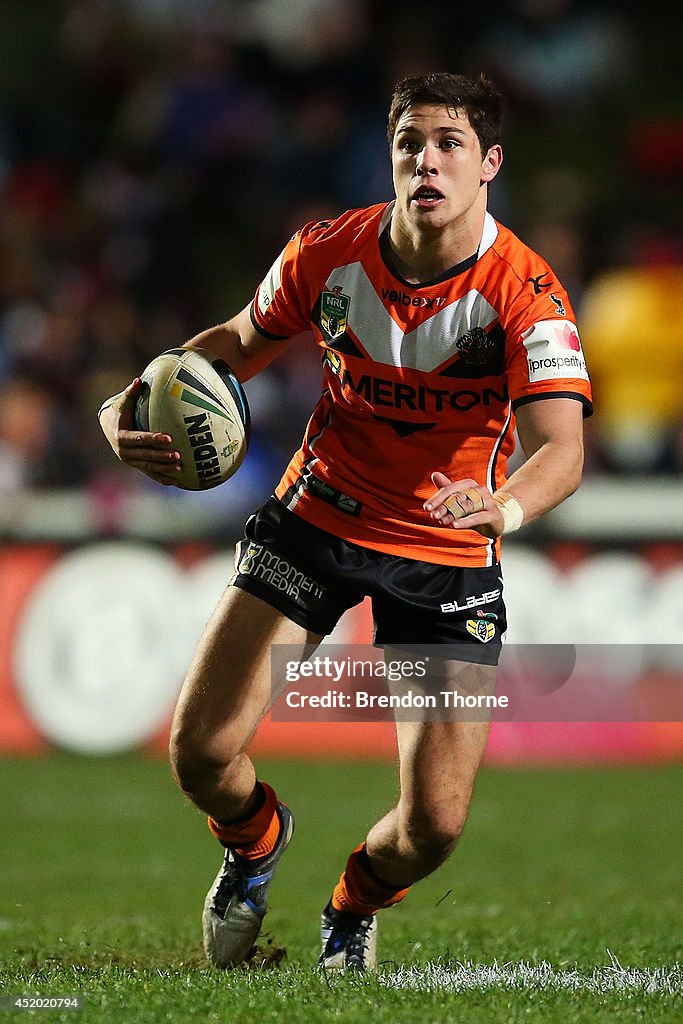 Michell Moses Mitchell Moses of the Tigers runs the ball during the round 18 NRL ...