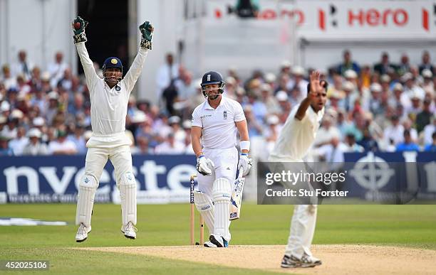 India captain Mahendra Singh Dhoni appeals with success for the wicket of England batsman Matt Prior off the bowling of Bhuvneshwar Kumar during day...